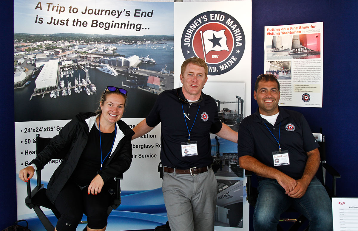 Exhibitors standing in front of a show display