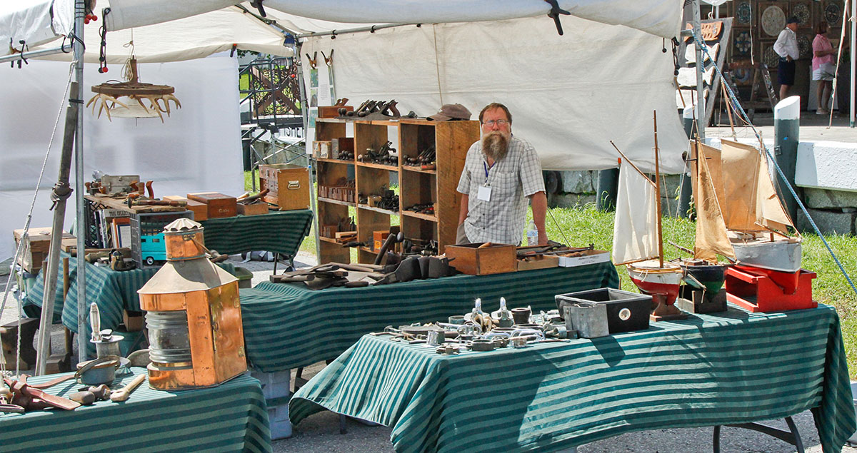 Exhibitors standing in front of a show display