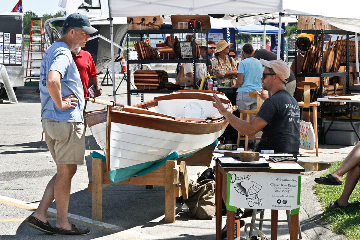 Visitors browsing exhibitor displays at the Maine Boat and Home Show