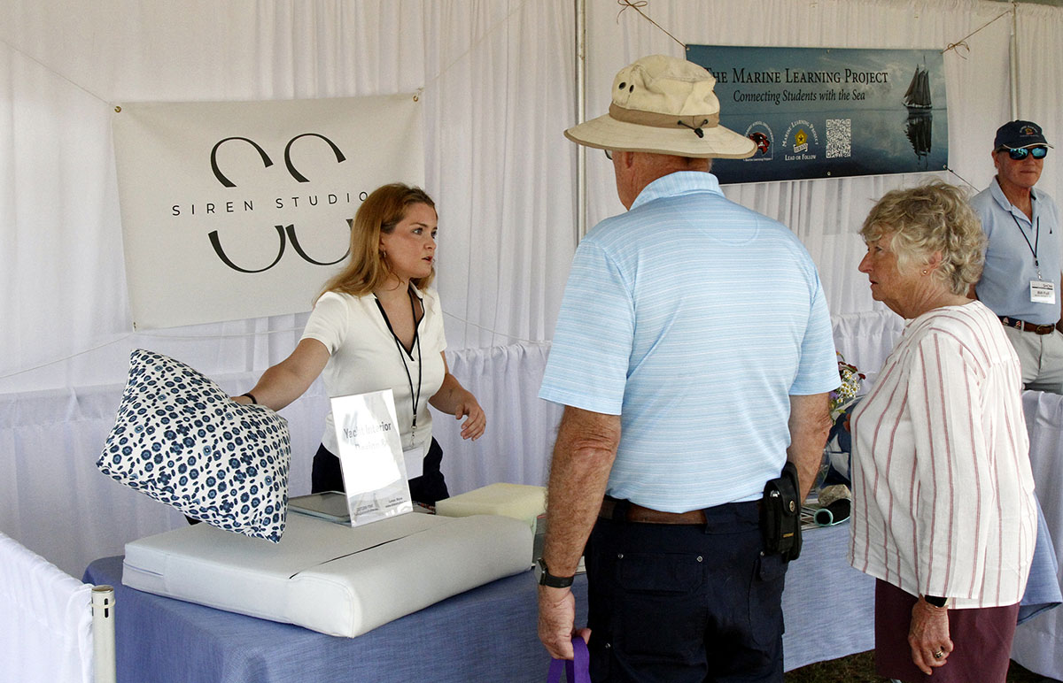 Visitors speaking with an exhibitor at the Maine Boat and Home Show