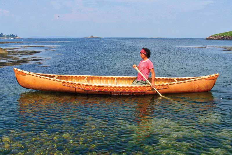 Native Americans were the earliest boat builders in Maine, build-ing dug-out canoes and then birchbark. Passamaquoddy artisan David Moses Bridges is shown in a canoe he built. Photo © Darel Gabriel Bridges